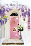 A tranquil Maida Vale entranceway is captured here as a quietly joyful celebration of arrival, where architecture and flowers come together in soft harmony. A pastel pink door, freshly painted and subtly luminous, stands at the centre, framed by smooth white walls that seem to gather and amplify the natural light common to the leafy avenues between Little Venice and Elgin Avenue. Above, generous garlands of wisteria spill in graceful arcs, their lavender blooms tumbling like fragrant tassels that brush the air just above the doorway, casting lace-like shadows on the façade. At the base of the door, resting neatly on the threshold, a simple grey metal bucket has been transformed by a florist's hand into a lush focal point: it overflows with creamy white roses, their rounded, velvety heads easing open, nestled among soft green foliage that peeks through in delicate sprigs. A pale pink ribbon wraps around the bucket and ties in a gentle bow, its colour echoing the door and suggesting a sense of careful intention and tenderness. The interplay of soft pinks, whites, greens, and purples creates a pastel palette that feels soothing yet quietly celebratory, an ideal backdrop for the moment when someone first turns the key in a new lock. You can almost sense the faint mingling of rose and wisteria perfume in the cool air and hear the reassuring quiet of a residential Maida Vale street. This doorway vignette feels perfectly suited for a housewarming, a new lease, or a thoughtful congratulatory delivery, capturing the reassuring message that this new address is ready to be filled with life, warmth, and belonging.
