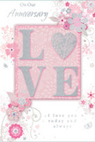 This anniversary card offers a soft, romantic scene that seems perfectly at home in the gentle rhythm of Maida Vale. At the centre, the word LOVE is spelled out in raised glitter, with each letter edged in soft sparkle and the O subtly suggested as a heartlike curve, shimmering in silver against a pastel pink ground. The texture of the lettering feels luxuriously tactile, like the velvety surface of fresh petals, encouraging the recipient to pause and trace the shapes with their fingertips. Surrounding this focal word, delicate blossoms in blush and mauve unfold in an almost watercolour softness, their edges blurred just enough to give the impression of movement. Fine ink lines sketch out stems, curling tendrils, and tiny flourishes that resemble petals and faint butterflies, capturing the grace of an English spring garden and echoing the kind of romantic arrangements a local Maida Vale florist might create with roses, soft seasonal blooms, and trailing greenery. Gentle tones of silver-grey weave through the design, highlighting certain petals and leaves so the light dances quietly across the card's surface. Above and below the central motif, the phrases On Our Anniversary and I love you today and always appear in an elegant, understated script that seems handwritten, conveying warmth without exaggeration. The overall palette of pastel pinks, silvery greys, and whispered mauves creates a sense of treasured intimacy, like a private celebration shared at home. It feels like a keepsake made to sit beside a vase of fresh anniversary flowers in Maida Vale-soft as a whisper, yet deeply heartfelt.